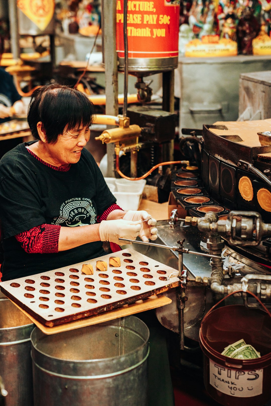 Operator inspecting confections on a cooling rack